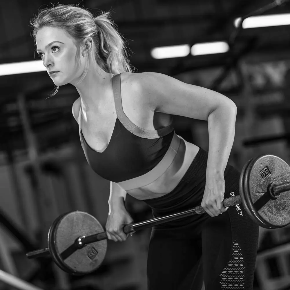 Olivia Kreigenfeld performing a barbell bent-over row at Physical Formula in Leamington Spa