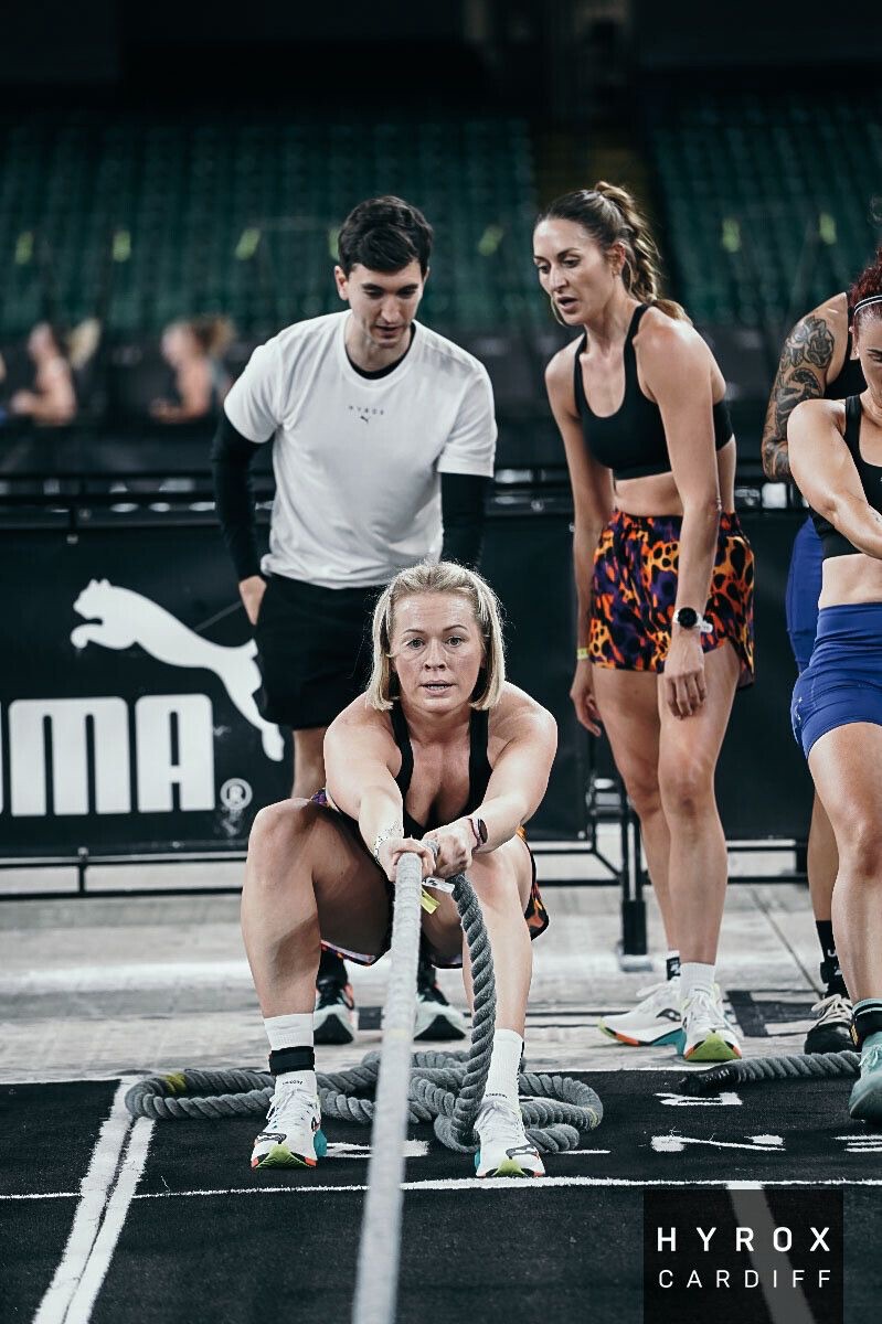 A coached group conditioning session on the battle ropes