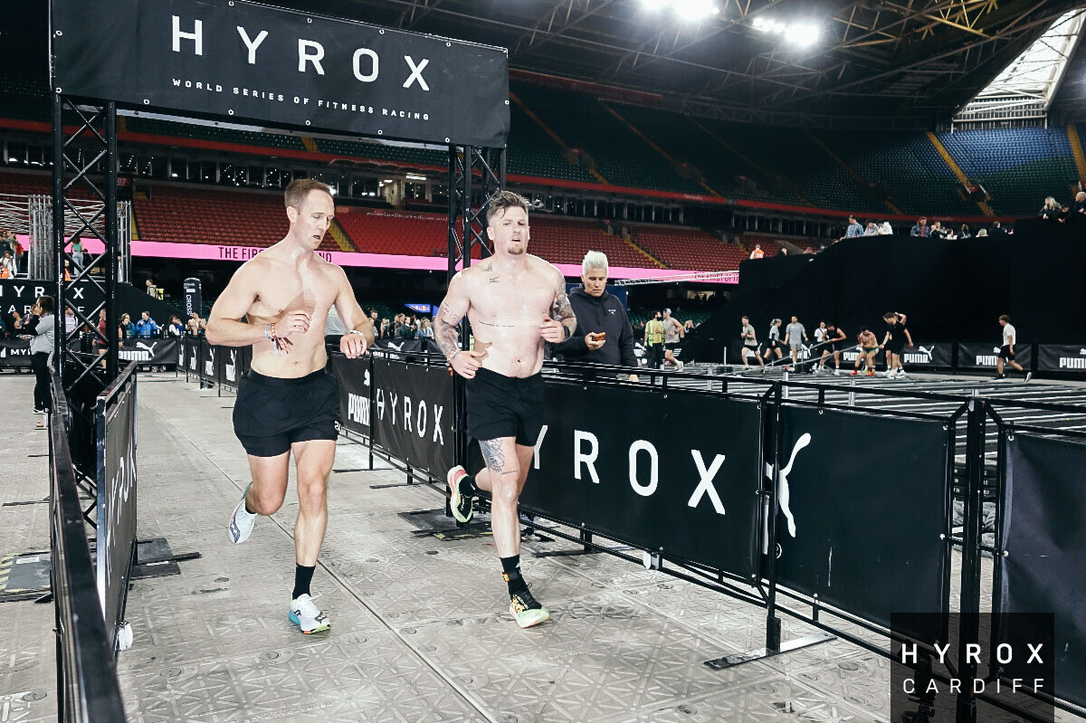 Athletes running between HYROX stations